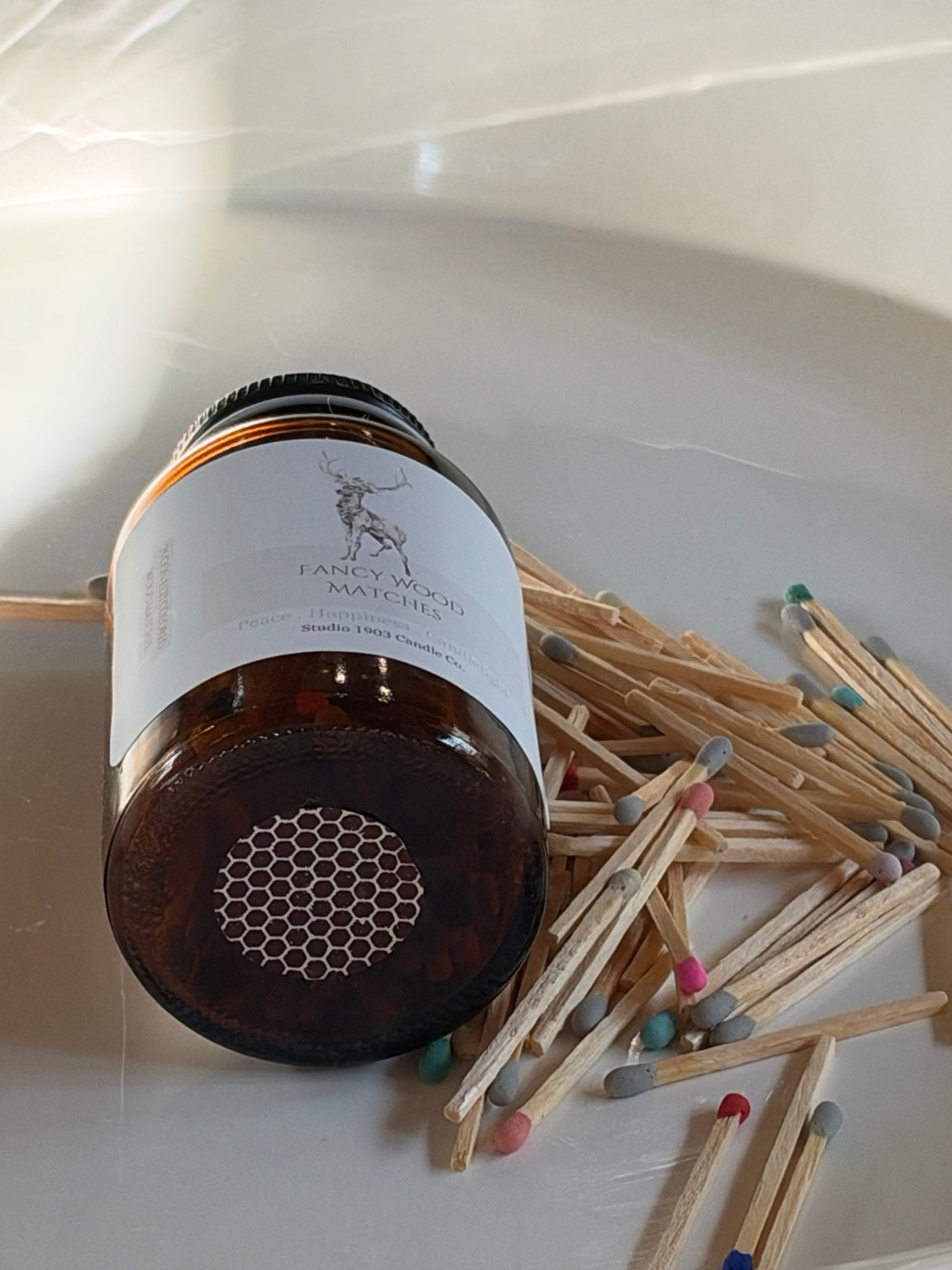 Strike sticker on bottom of amber glass match jar