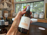 Orange Blossom Honey room spray held in the Studio 1903 sunroom