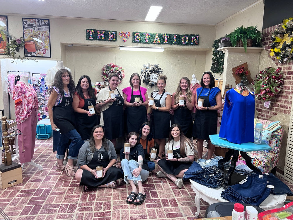 Boutique workshop group holding their finished candles