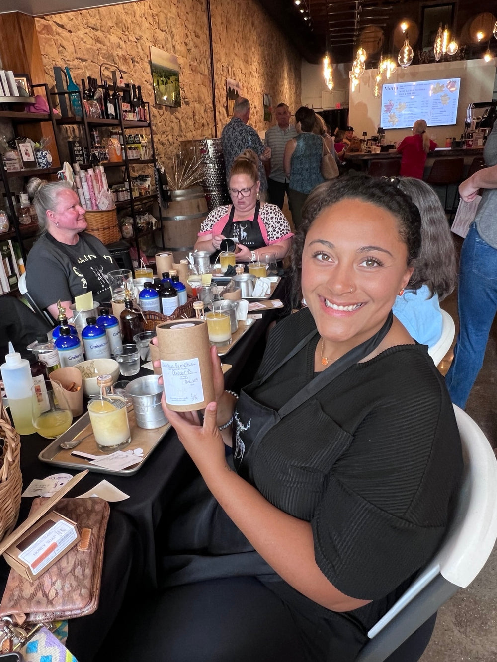 Workshop guest smiling with her finished candle