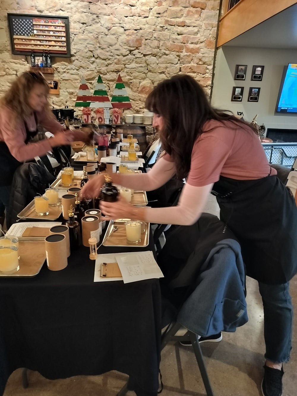 Two workshop guests working with fragrance bottles at the table