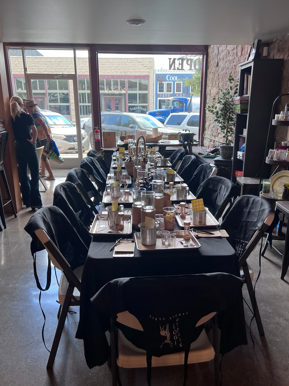 Workshop table set with candle-making supplies in a storefront